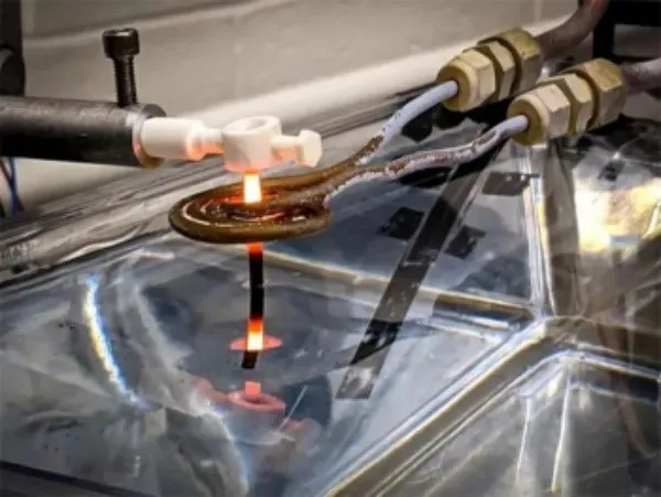 A thin 3D printed superalloy rod is pulled out of the water bath A thin 3D printed superalloy rod is pulled out of the water bath